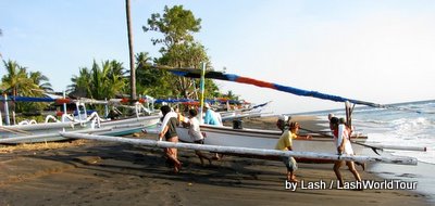 fishermen returning jukung to beach- Amed