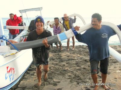 fishermen returning jukung to beach- Amed- Bali 