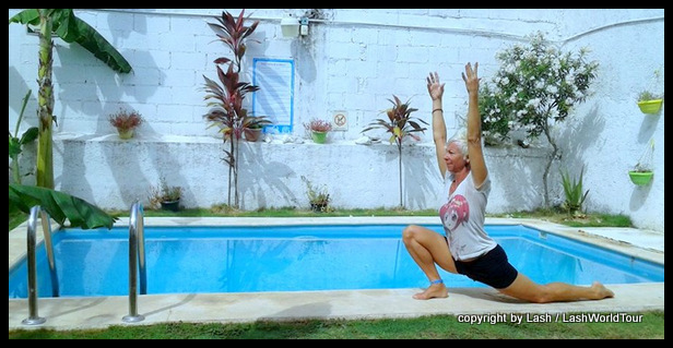 Lash doing yoga poolside in hostel