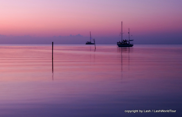 Calm Belize sunset over sea in lavender