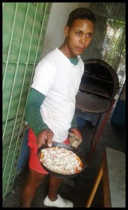 preparing pizza at a small pizza shop  in Trinidad
